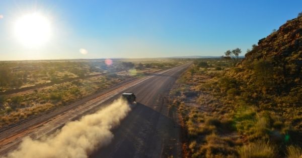 Car driving on a rural dirt road